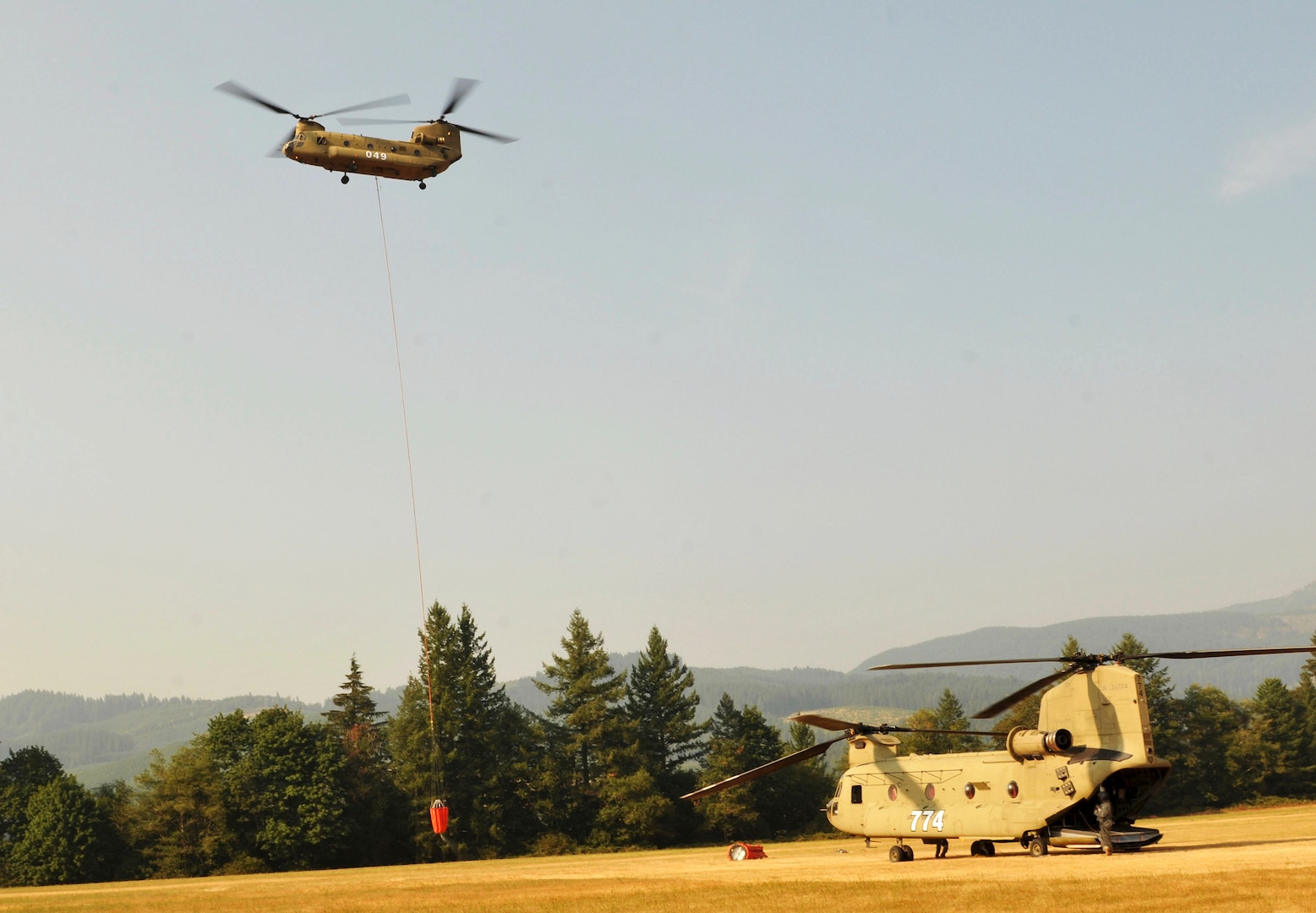 Oregon Army National Guard Soldiers with 1st Battalion, 168th Aviation Regiment, land a CH-47 Chinook helicopter for refueling at Davis helibase near Gates, Oregon, August 7, 2017. Some Guard crews and helicopters have been mobilized this week to assist in wildfire suppression efforts in the state.