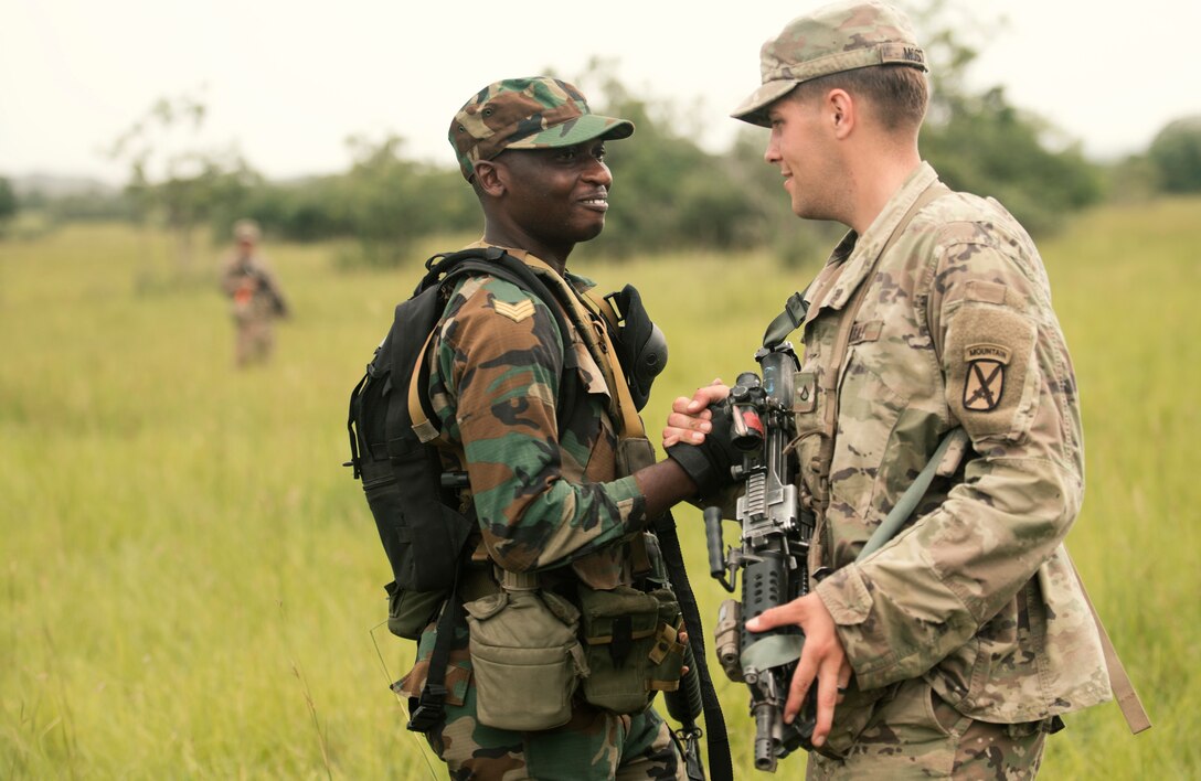 A Ghanaian soldier greets an American soldier.