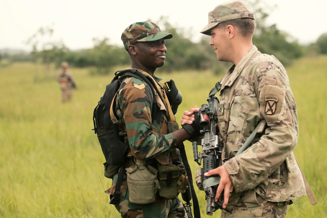 A U.S. and Ghanaian soldier shake hands during a training exercise in Ghana.