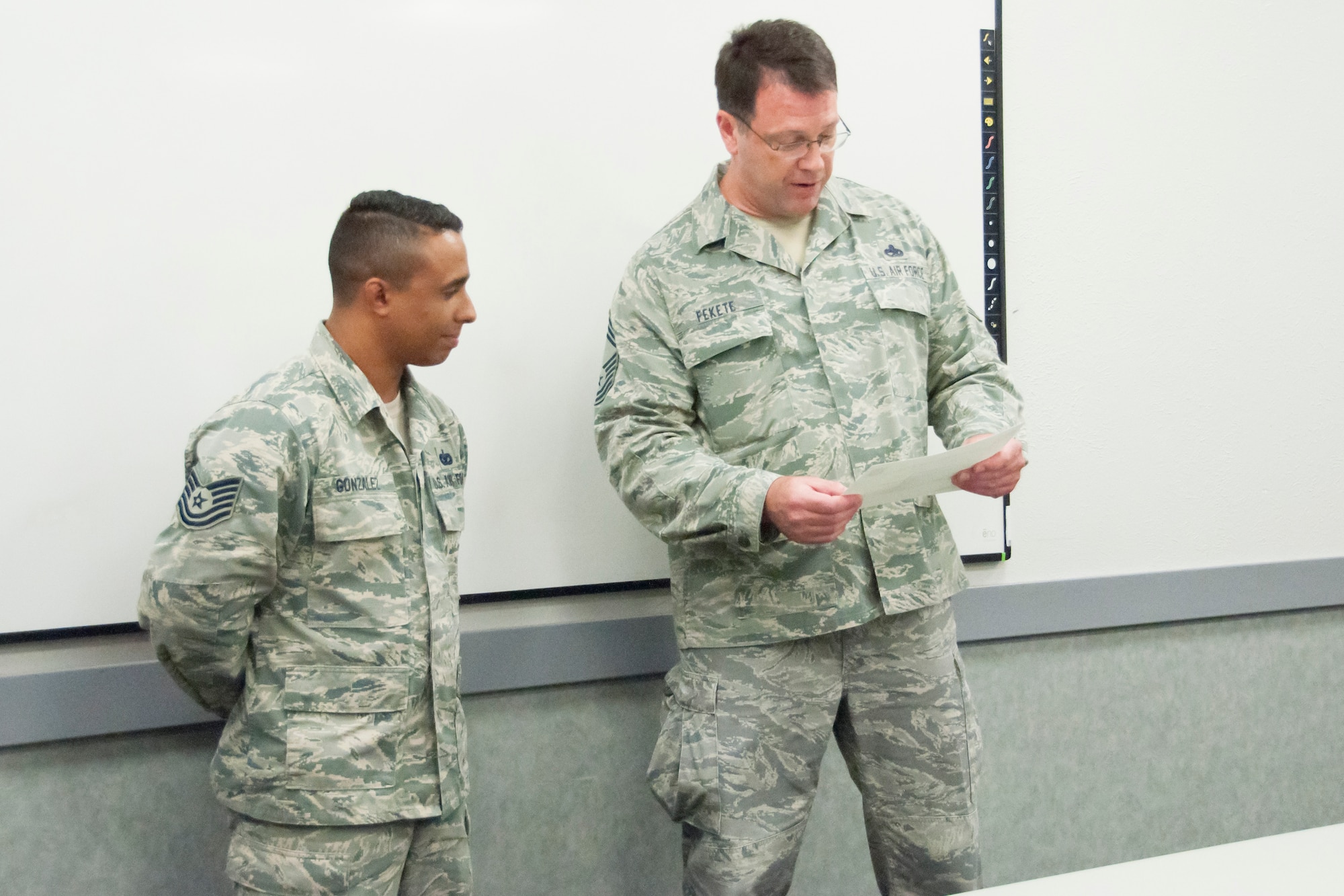 Tech. Sgt. Carlos Gonzalez, 302nd Security Forces Squadron, accepts a Chief’s Group Excellence Award from Chief Master Sgt. Michael Fekete, president of the 302nd Airlift Wing Chief’s Group, July 15, 2018 at Peterson Air Force Base, Colorado. The award was presented for the work Gonzalez did to provide 302nd Airlift Wing members with expeditionary active shooter training. (U.S. Air Force photo by Staff Sgt. Heather Heiney)