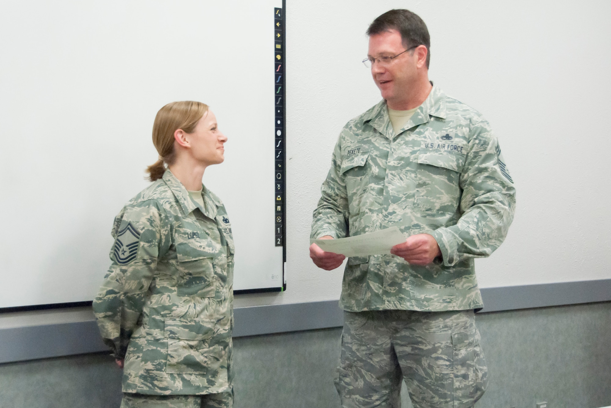 Senior Master Sgt. Tina Lopez, 302nd Security Forces Squadron, accepts a Chief’s Group Excellence Award on behalf of her husband, Master Sgt. Isaac Lopez, who is now retired, from Chief Master Sgt. Michael Fekete, president of the 302nd Airlift Wing Chief’s Group, July 15, 2018 at Peterson Air Force Base, Colorado. The award was presented for the work Lopez did to provide 302nd Airlift Wing members with combat arms training. (U.S. Air Force photo by Staff Sgt. Heather Heiney)