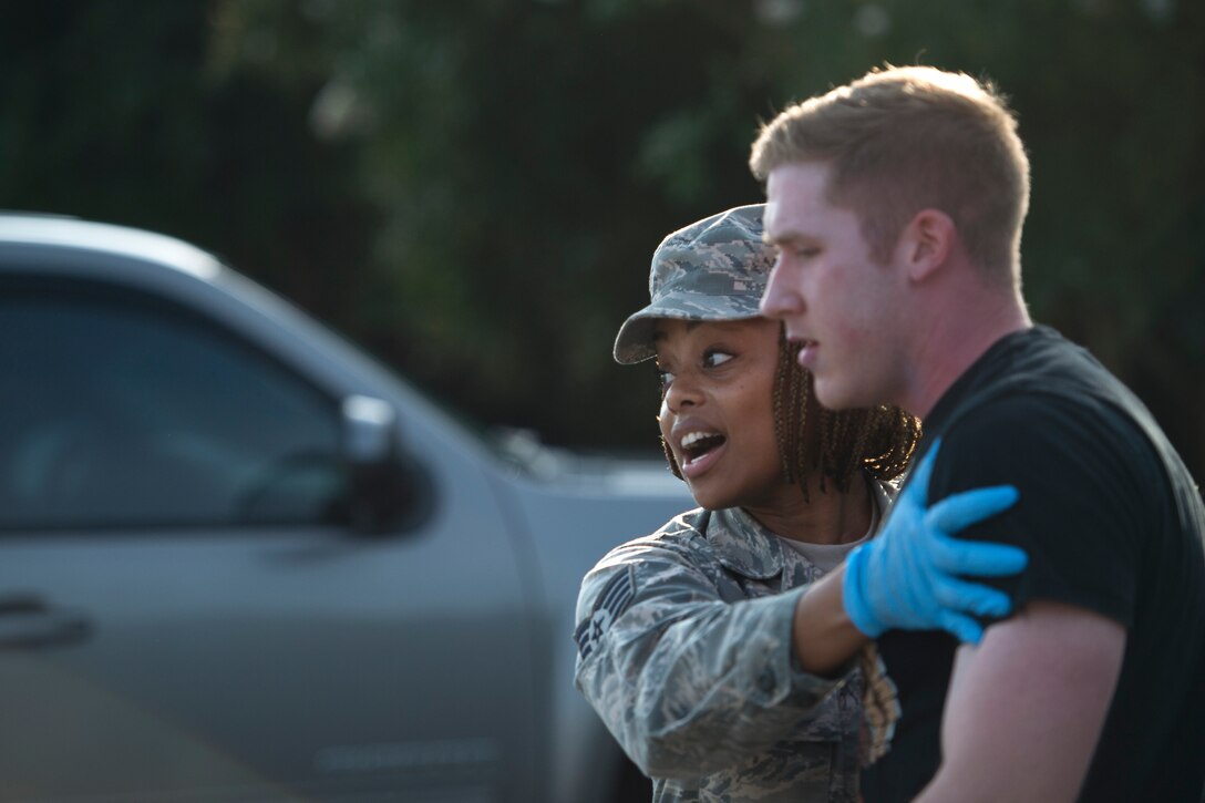 A first responder from the 23d Medical Group attempts to calm a simulated victim during a mass casualty exercise July 19, 2018, at Moody Air Force Base, Ga. The exercise tested the MDG’s emergency response capabilities during a chemical attack. (U.S. Air Force photo by Senior Airman Janiqua P. Robinson)