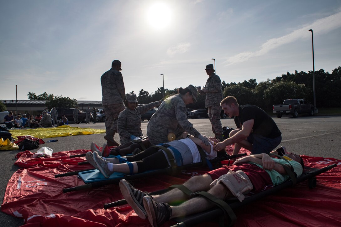 Airmen from the 23d Medical Group treat simulated victims during a mass casualty exercise July 19, 2018, at Moody Air Force Base, Ga. The exercise tested the MDG’s emergency response capabilities during a chemical attack. (U.S. Air Force photo by Senior Airman Janiqua P. Robinson)