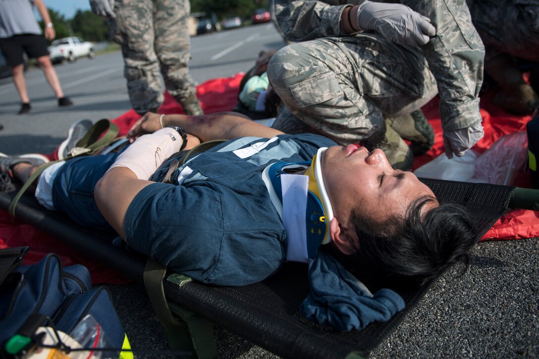 Airmen from the 23d Medical Group treat a simulated victim during a mass casualty exercise July 19, 2018, at Moody Air Force Base, Ga. The exercise tested the emergency response capabilities during a chemical attack. (U.S. Air Force photo by Senior Airman Janiqua P. Robinson)