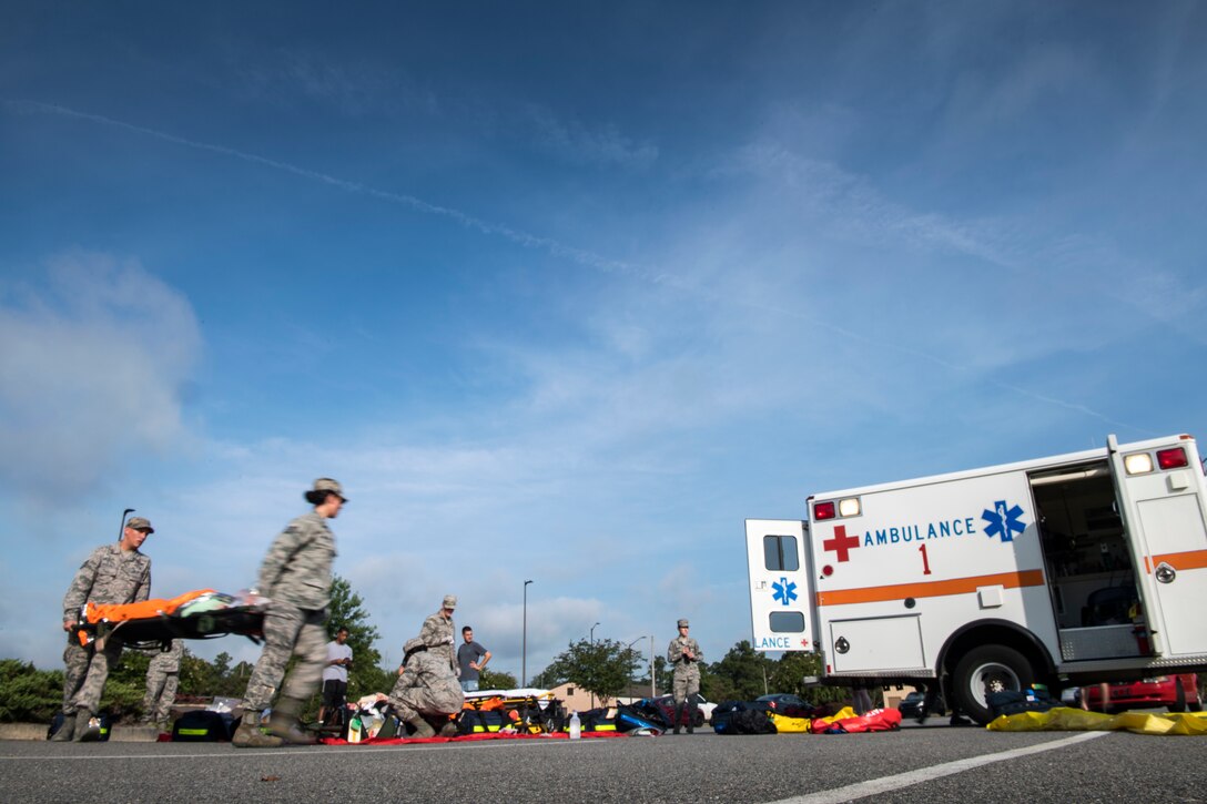 Airmen from the 23d Medical Group load a simulated victim into an ambulance during a mass casualty exercise July 19, 2018, at Moody Air Force Base, Ga. The exercise tested the MDG’s emergency response capabilities during a chemical attack. (U.S. Air Force photo by Senior Airman Janiqua P. Robinson)