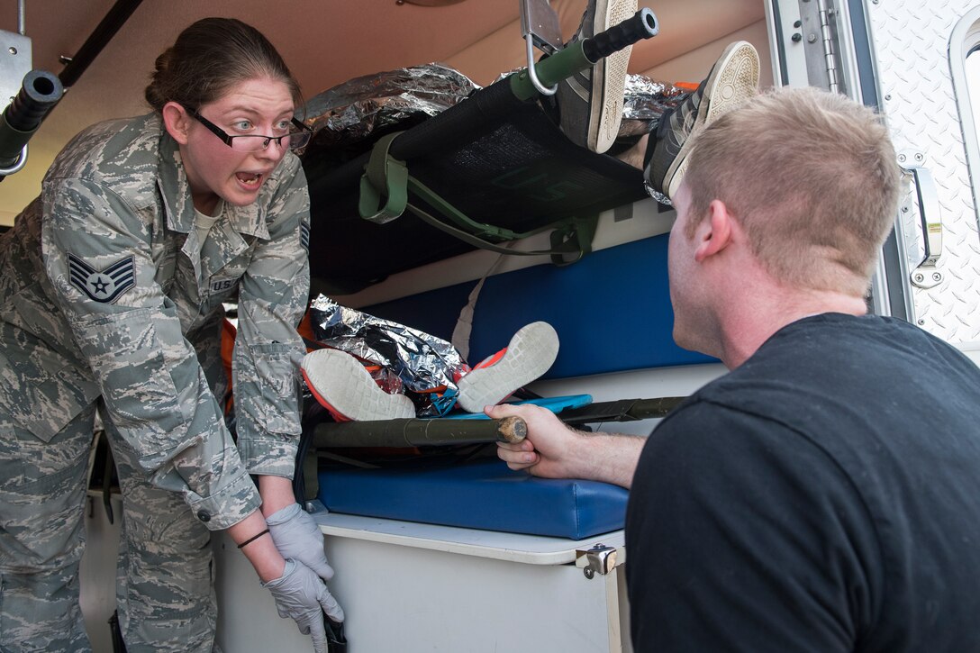 A first responder from the 23d Medical Group instructs a simulated victim during a mass casualty exercise July 19, 2018, at Moody Air Force Base, Ga. The exercise tested the MDG’s emergency response capabilities during a chemical attack. (U.S. Air Force photo by Senior Airman Janiqua P. Robinson)