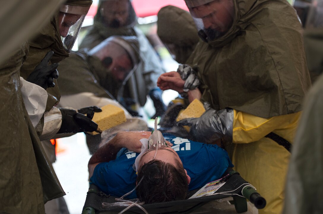 Airmen from the 23d Medical Group wash a simulated victim during a mass casualty exercise July 19, 2018, at Moody Air Force Base, Ga. The exercise tested the MDG’s emergency response capabilities during a chemical attack. (U.S. Air Force photo by Senior Airman Janiqua P. Robinson)