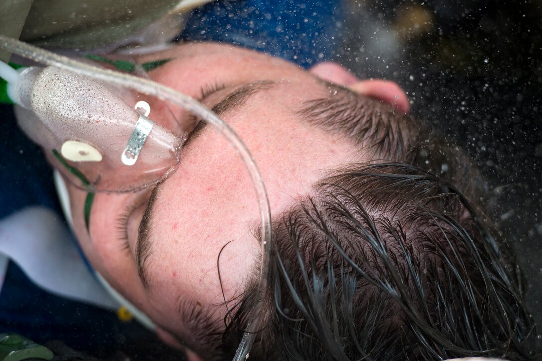 A simulated victim moves through a decontamination line during a mass casualty exercise July 19, 2018, at Moody Air Force Base, Ga. The exercise tested the 23d Medical Group’s emergency response capabilities during a chemical attack. (U.S. Air Force photo by Senior Airman Janiqua P. Robinson)