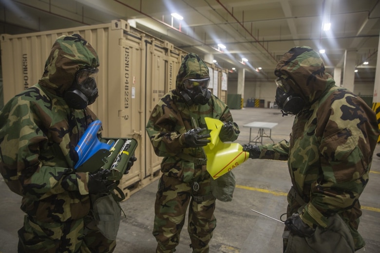Marines place marked flags around a point of contamination during a reconnaissance, surveillance and decontamination course conducted by chemical, biological, radiological and nuclear Marines with Combat Logistics Regiment 35, 3rd Marine Logistics Group July 17, 2018 at Camp Kinser, Okinawa, Japan.