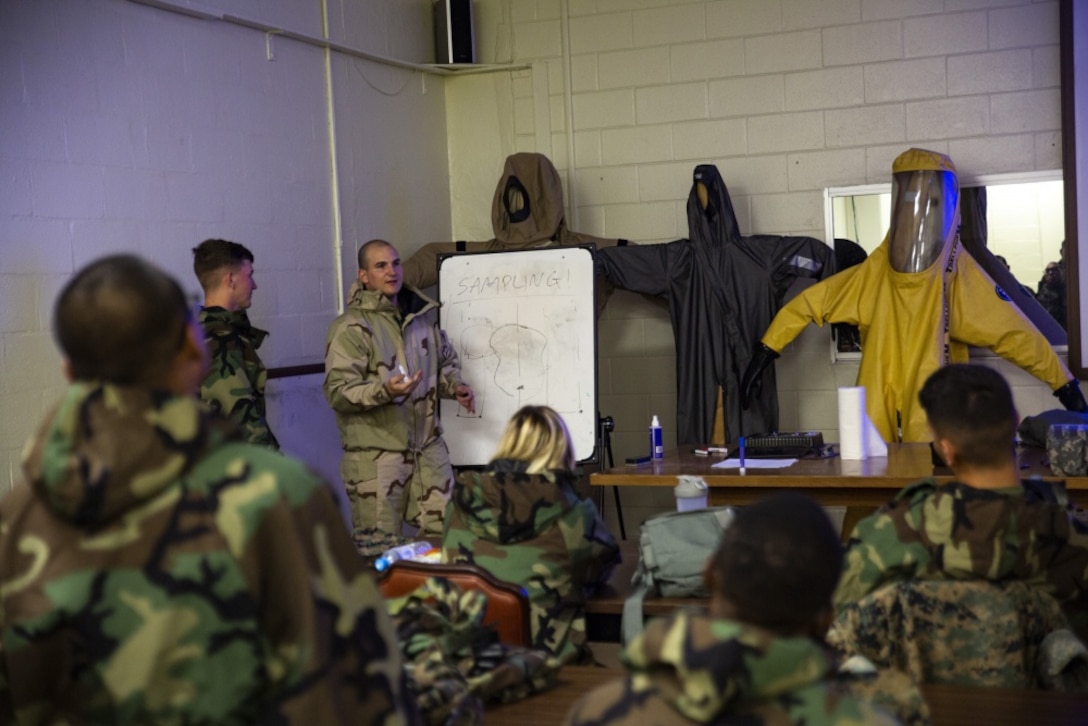 Cpl. Tyler J. Beard, center-left, instructs Marines on the sampling and testing of chemicals during a reconnaissance, surveillance and decontamination course conducted by chemical, biological, radiological and nuclear Marines with Combat Logistics Regiment 35, 3rd Marine Logistics Group July 18, 2018 at Camp Kinser, Okinawa, Japan. The RSD course ensures that Marines can effectively detect and decontaminate a CBRN environment and save lives of contaminated Marines in an area. Beard, a native of Pearland, Texas, is a CBRN defense specialist with CLR-35.