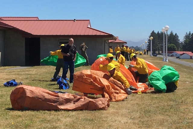 National Guardsmen train to set up emergency fire shelters.