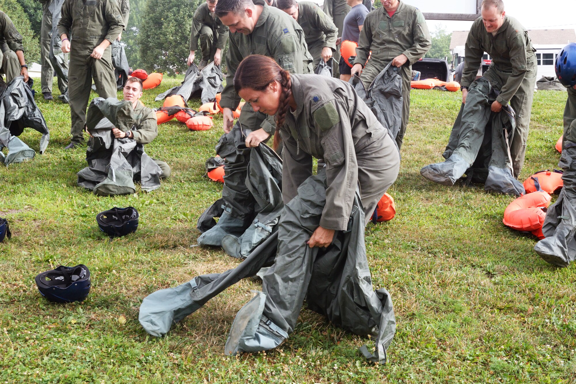 Lt. Col. Wendy Squarica, 238th Combat Training Squadron commander and Citizen Airman, dons an anti-exposure suit while participating in water survival and rescue training July 14, 2018. The suits are worn by aircrew in the eventuality they must be in water where the temperature is below 60 F. The hands-on water instruction included donning cold-water exposure suits; inflating and swimming with inflatable life preservers; and boarding and utilizing a 20-person survival raft.
