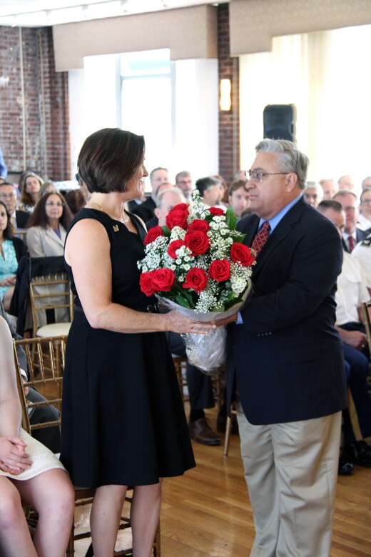 Civilian engineer Ralph Lamoglia presents Janet Graham, wife of out-going commander Maj. Gen. William H. Graham, in appreciation during the U.S. Army Corps of Engineers North Atlantic Division change-of-command ceremony.