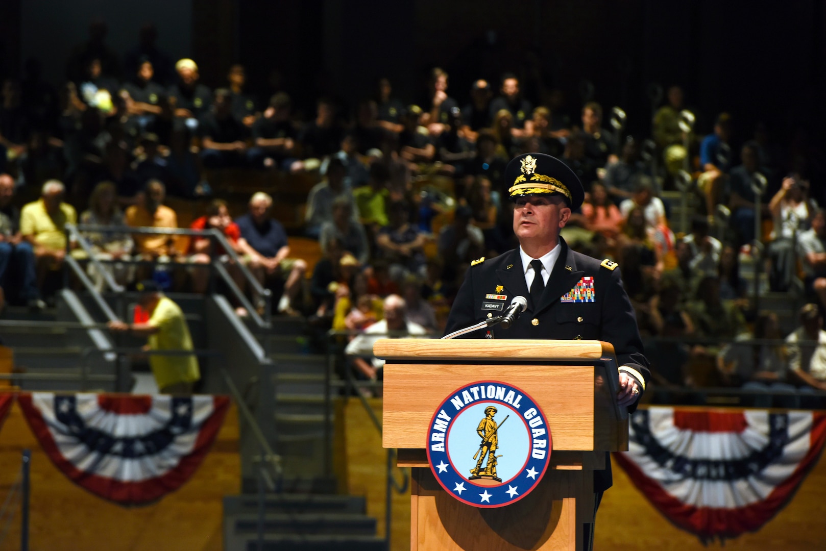 Army Lt. Gen. Timothy Kadavy, the director of the Army National Guard, speaks to more than 500 attendees during the Twilight Tattoo, July 18, 2018, at Joint Base Myer-Henderson Hall, Virginia. Kadavy served as host for the event, and recognized civilian employers of Guard members and administered the oath of enlistment to more than 50 future Soldiers.