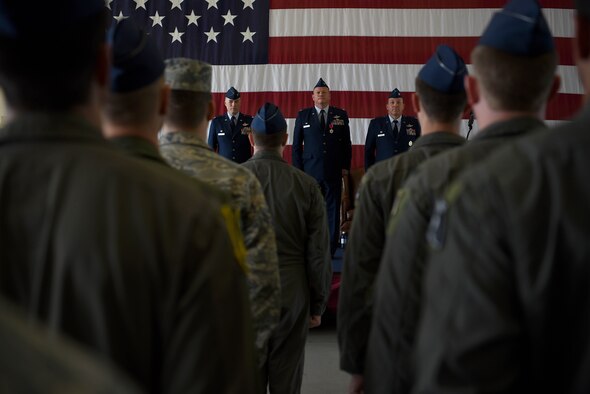 Col. Douglas Gosney, 14th Flying Training Wing commander, stands at attention with Col. Stan Lawrie and Col. Derek Stuart, before Lawrie relinquishes command of the 14th Operations Group to Stuart July 10, 2018, on Columbus Air Force Base, Mississippi. The Air Force has a Permanent Change of Station cycle causing summers to have more of these ceremonies in comparison to the winter. (U.S. Air Force photo by Airman 1st Class Keith Holcomb)