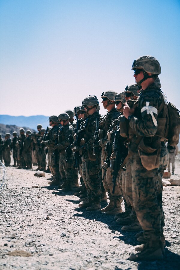Marines in the Infantry Officer Course prepare to begin their live fire training exercise at Range 410A aboard the Marine Corps Air Ground Combat Center, Twentynine Palms, Calif., June 9, 2018. The Purpose of IOC is to train and educate newly selected infantry and ground intelligence officers in leadership, infantry skills, character required to serve as infantry platoon commanders in the operating forces. (U.S. Marine Corps photo by Lance Cpl. William Chockey)
