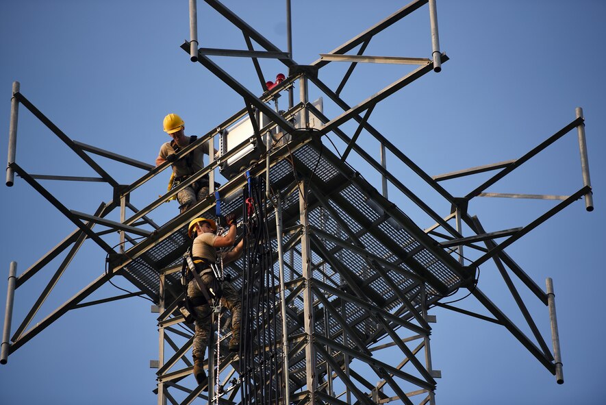 Airman Jacob Pugh and Airman 1st Class Brandon Culp, 14th Operations Support Squadron Radar, Airfield and Weather Systems (RAWS) journeymen, attach new wiring on a radio tower July 16, 2018, on Columbus Air Force Base, Mississippi. The RAWS unit supports base and regional radar equipment, ground-to-air radios and weather systems that support Air Traffic Control, the National Weather Service, and command and control across the wing. (U.S. Air Force photo by Airman 1st Class Keith Holcomb)