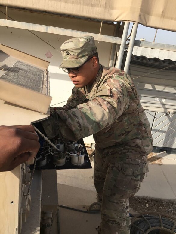 Pfc. Manu Sogelau, of San Francisco, Calif., a power generation specialist assigned to Delta Battery, 5th Battalion 52nd Air Defense Artillery Regiment, conducts maintenance on a 30Kw tactical generator.