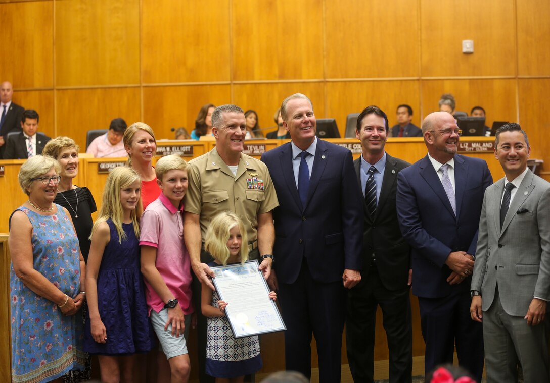 Col. Jason G. Woodworth, commanding officer of Marine Corps Air Station Miramar, and his family pose for a photo beside San Diego’s Mayor, Kevin Faulconer, and city council members Mark Kersey, Scott Sherman and Chris Cate during a city council meeting at San Diego City Hall, San Diego, July 17, 2018. San Diego proclaimed July 17 as “Colonel Jason Woodworth Day”, after recognizing Col. Woodworth’s accomplishments and role in building a better relationship with the city and MCAS Miramar, as commanding officer. (U.S. Marine Corps Photo by Sgt. Daniel Auvert/Released)