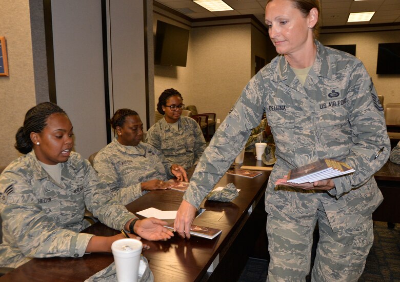 Senior Master Sgt. Tricia DeLuna, Manager, Military Personnel Division, 1st Air Force (Air Forces Northern) and “Four Lenses 4-Terperament Discovery” course facilitator, distributes course guides to the class July 12. The course is a personality assessment tool that helps participants enhance both their own self-awareness and their interpersonal communication skills. (Air Force photo by Mary McHale)
