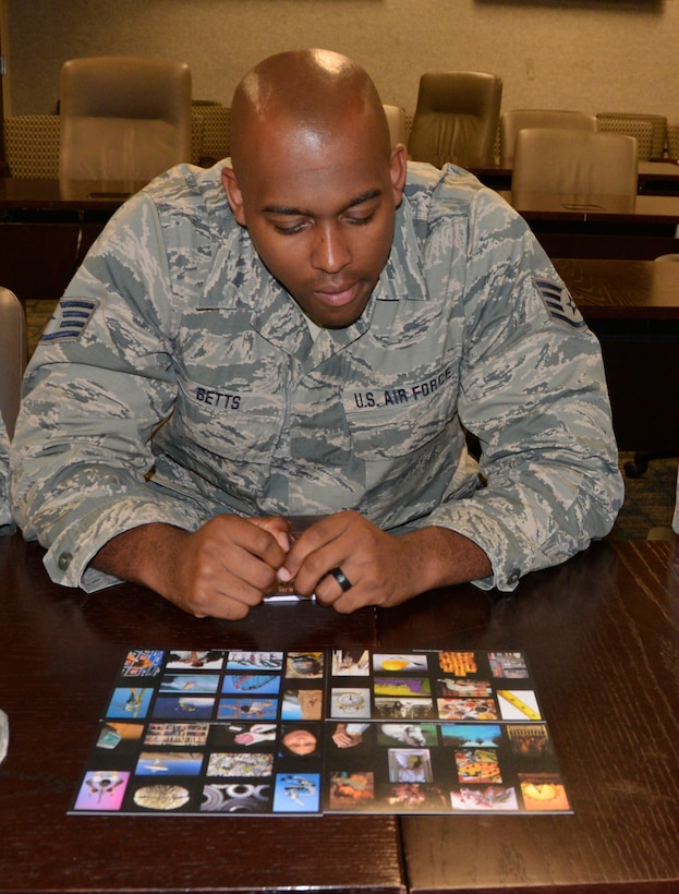 Staff Sgt. Matthew Betts, personnel journeyman, 186th Air Operations Group, Meridian, Miss., looks over the course cards July 12 during the “Four Lenses 4-Terperament Discovery” course. The course is a personality assessment tool that helps participants enhance both their own self-awareness and their interpersonal communication skills. (Air Force photo by Mary McHale)