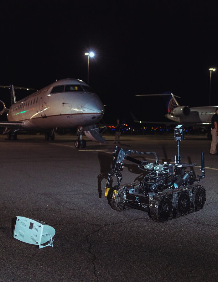 A remote-controlled robot examines a possible home-made explosive during at Operation Bono at Palm Springs International Airport, Palm Springs, Calif., July 13, 2018. The purpose of Operation Bono is to provide unique training opportunities for federal, state, and local public safety bomb squads and military explosive ordnance disposal teams, as well as facilitates training and drills designed for bomb squads to employ their tactics while operating in the aviation domain in, and around PSP airport. (U.S. Marine Corps photo by Lance Cpl. Rachel K. Porter)