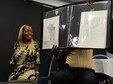 Tawana Williams, motivational speaker, and her husband, Toby, showcase her artwork July 16, 2018, at Columbus Air Force Base, Mississippi. Williams demonstrated how she cared for a child, signs her name and tied a young boy’s shoes all with just her feet. (U.S. Air Force Photo by Airman 1st Class Beaux Hebert)