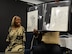 Tawana Williams, motivational speaker, and her husband, Toby, showcase her artwork July 16, 2018, at Columbus Air Force Base, Mississippi. Williams demonstrated how she cared for a child, signs her name and tied a young boy’s shoes all with just her feet. (U.S. Air Force Photo by Airman 1st Class Beaux Hebert)