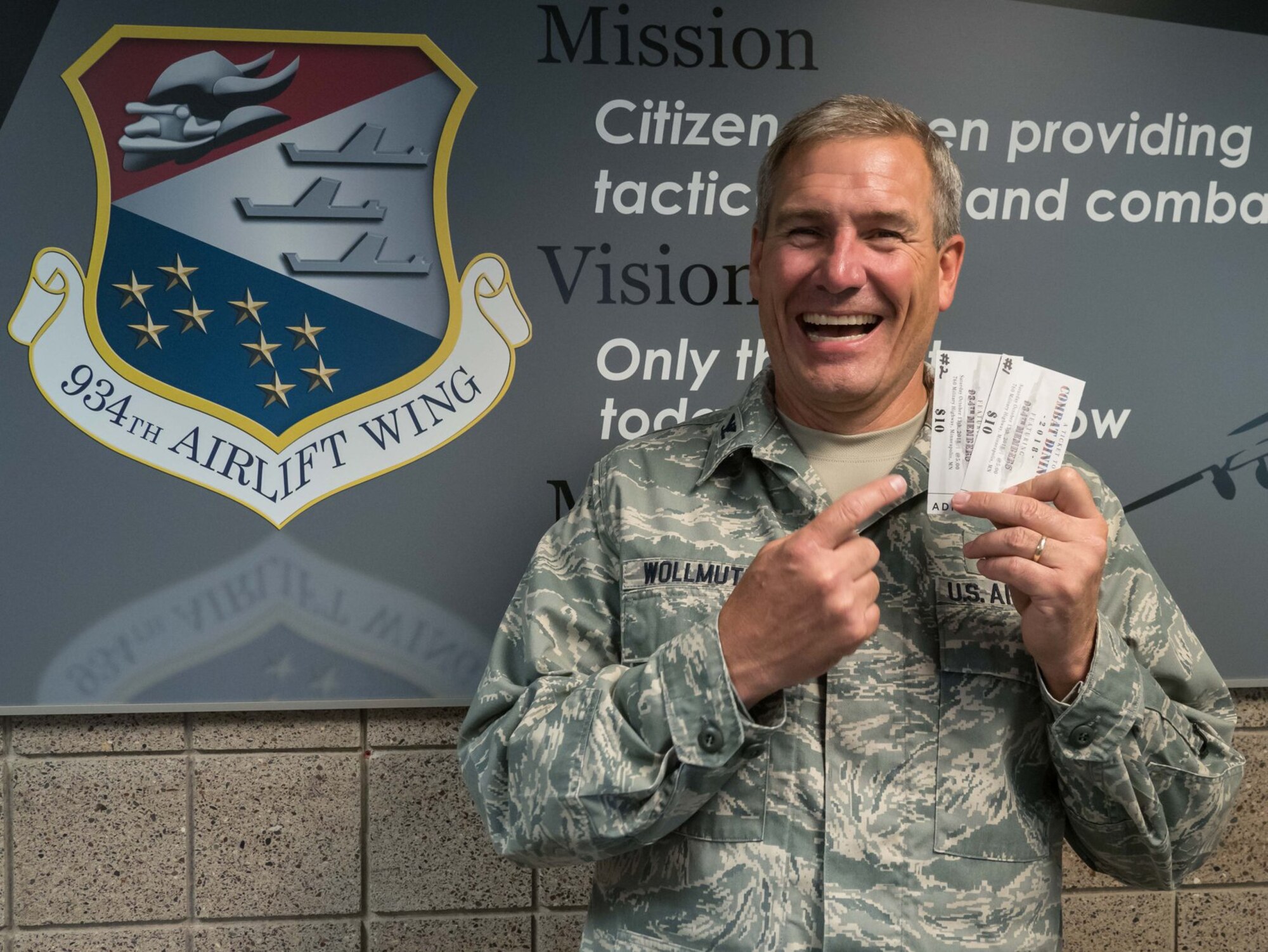 Col. Tim Wollmuth, 934th Airlift Wing vice commander, displays the first two tickets sold to the Wing Combat Dining In Oct. 13.  Get your tickets for $10 each from your first sergeant. (Air Force Photo/Paul Zadach)