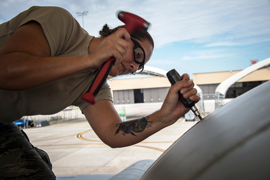 Airman 1st Class Lisha West, 74th Aircraft Maintenance Unit (AMU) aerospace propulsion technician, removes the panel of an A-10C Thunderbolt II, July 17, 2018, at Moody Air Force Base, Ga.  Airmen from the 74th AMU play a part in the upkeep and maintenance of the Air Force’s largest operational A-10C Thunderbolt II fighter group.  Maintainers from the 74th AMU accomplished a repair on a Turbo-Fan-34 engine in 48 operational hours. (U.S. Air Force photo by Airman 1st Class Eugene Oliver)