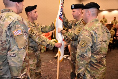 Lt. Col. Matthew Mapes, 6th Medical Recruiting Battalion outgoing commander, relinquishes the battalion colors to Col. Edward Mandril, Medical Recruiting Brigade commander and presiding officer during the 6th MRBn Change of Command Ceremony on July 19.