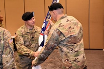 Lt. Col. Kenneth Lutz, 6th Medical Recruiting Battalion incoming commander, presents the battalion colors to Command Sgt. Maj. James E. Stevens, during the 6th MRBn Change of Command Ceremony on July 19.