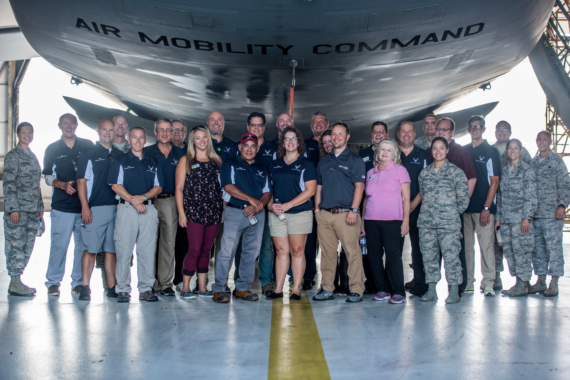Team Dover service members and honorary commanders pose for a group photo at Dover Air Force Base, Del., July 19, 2018. The Honorary Commander Program fosters a bond between civic leaders and the U.S. Air Force and engages, educates and empowers community leaders to advocate for Airmen and their families. (U.S. Air Force photo by Staff Sgt. Damien Taylor)