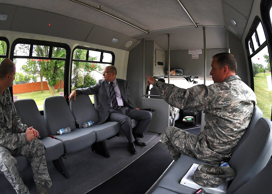 Dominic Pohl, 25th Air Force executive director, center, rides with Col. Benjamin Spencer, 319th Air Base Wing commander, right, and Col. Bart Yates, 319ABW vice commander, through base housing July 19, 2018, on Grand Forks Air Force Base, North Dakota. Pohl was interested in seeing the housing area in order to understand the quality of life for those who choose to live on base. (U.S. Air Force photo by Airman 1st Class Elora J. Martinez)