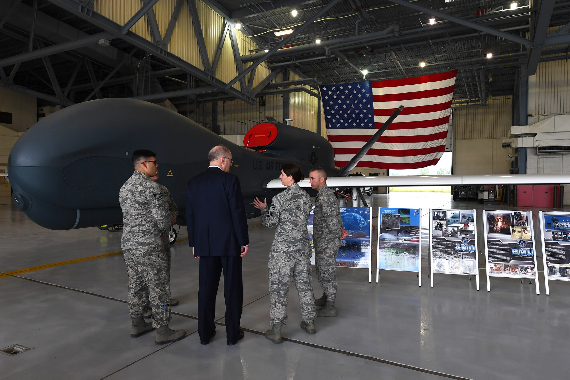 Dominic Pohl, 25th Air Force executive director, center, listens to Chief Master Sgt. Shannon Thomas, 69th Maintenance Group superintendent, center-right, explain the intelligence, surveillance and reconnaissance capabilities of the RQ-4 Global Hawk July 20, 2018, on Grand Forks Air Force Base, North Dakota. The 69 MXS mission plays a large role on Grand Forks AFB, operating Global Hawk missions year-round to offer ISR abilities worldwide. (U.S. Air Force photo by Airman 1st Class Elora J. Martinez)