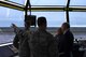 Dominic Pohl, 25th Air Force executive director, right, observes the base geography and flight line through the air traffic control tower windows July 20, 2018, on Grand Forks Air Force Base, North Dakota. Air traffic controllers shared their day-to-day operations with Pohl, detailing how they manage the air space and communicate with aircraft. (U.S. Air Force photo by Airman 1st Class Elora J. Martinez)