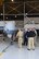 Dominic Pohl, 25th Air Force executive director, center, learns more about the MQ-9 Raptor used by Customs and Border Protection July 20, 2018, on Grand Forks Air Force Base, North Dakota. David Fulcher, CBP director of operations, left, shared with Pohl the specifications of the unmanned aircraft, to include infrared-imaging and long-endurance abilities. (U.S. Air Force photo by Airman 1st Class Elora J. Martinez)