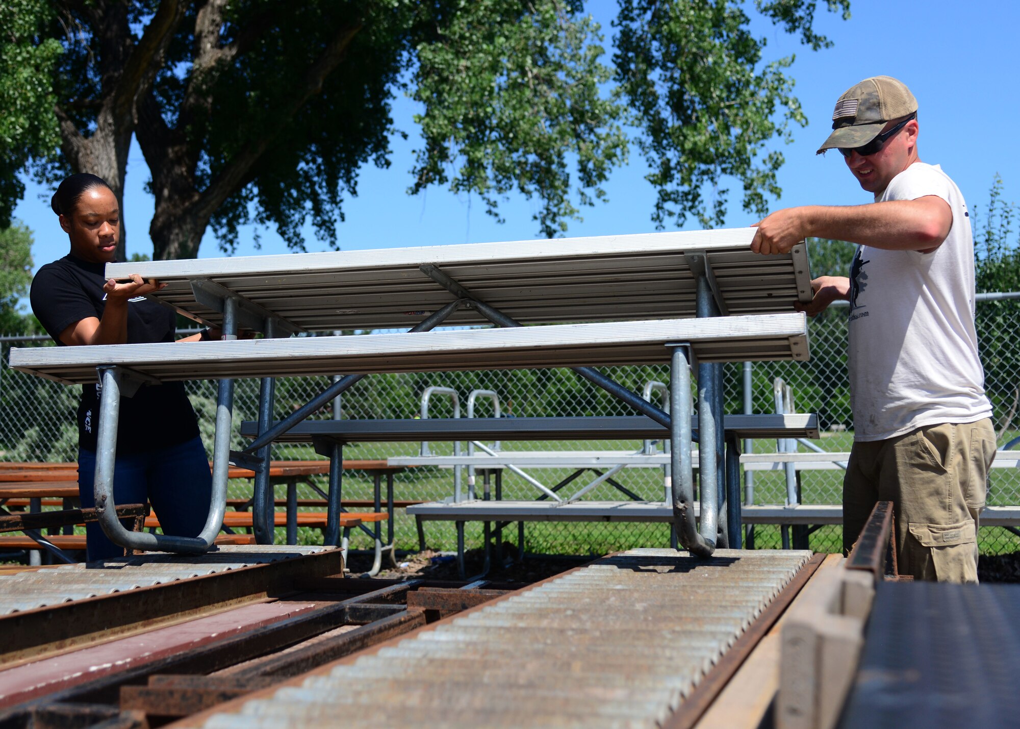 A team of Airmen from the 28th Civil Engineer Squadron volunteered their time to help set up for Summer Nights in downtown Rapid City, S.D., July 19, 2018. The Airmen moved tables and trash cans to the downtown area, while another group completed the set up. Summer Nights is a free event which takes place every Thursday night during the summer, providing live music and entertainment.