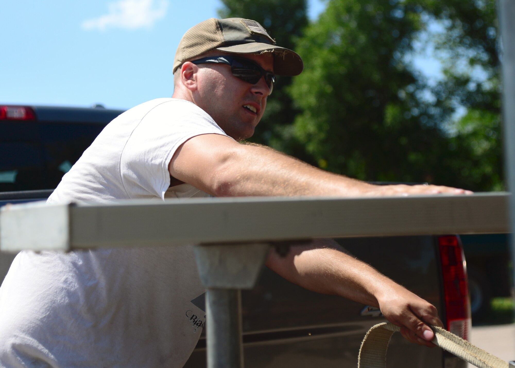 A team of Airmen from the 28th Civil Engineer Squadron volunteered their time to help set up for Summer Nights in downtown Rapid City, S.D., July 19, 2018. The Airmen moved tables and trash cans to the downtown area, while another group completed the set up. Summer Nights is a free event which takes place every Thursday night during the summer, providing live music and entertainment.