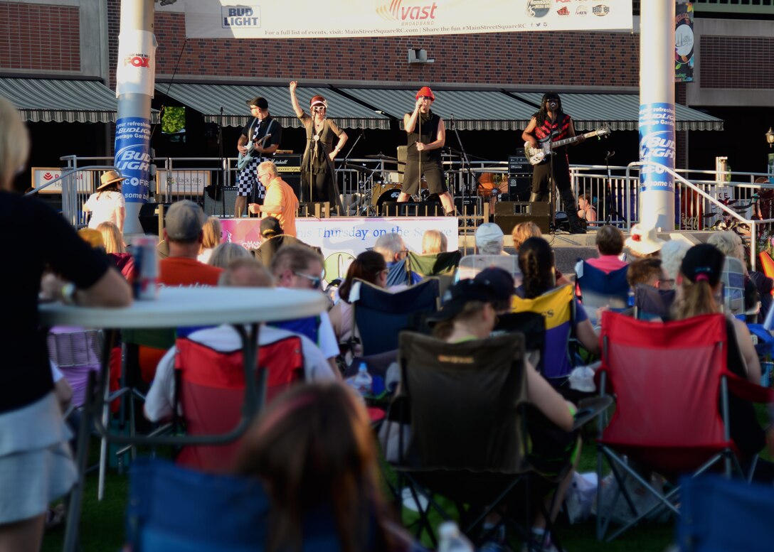 A team of Airmen from the 28th Civil Engineer Squadron volunteered their time to help set up for Summer Nights in downtown Rapid City, S.D., July 19, 2018. The Airmen moved tables and trash cans to the downtown area, while another group completed the set up. Summer Nights is a free event which takes place every Thursday night during the summer, providing live music and entertainment.