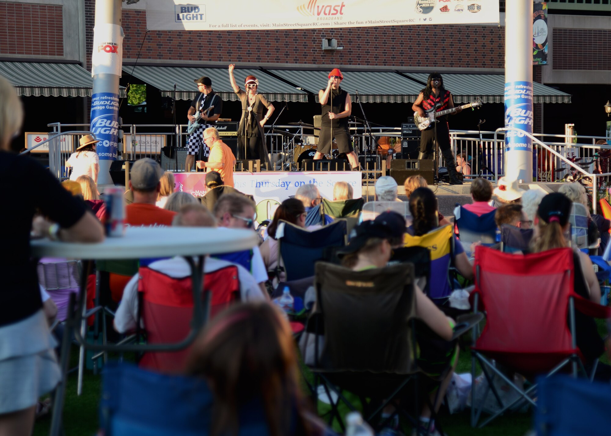 A team of Airmen from the 28th Civil Engineer Squadron volunteered their time to help set up for Summer Nights in downtown Rapid City, S.D., July 19, 2018. The Airmen moved tables and trash cans to the downtown area, while another group completed the set up. Summer Nights is a free event which takes place every Thursday night during the summer, providing live music and entertainment.