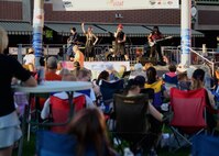 A team of Airmen from the 28th Civil Engineer Squadron volunteered their time to help set up for Summer Nights in downtown Rapid City, S.D., July 19, 2018. The Airmen moved tables and trash cans to the downtown area, while another group completed the set up. Summer Nights is a free event which takes place every Thursday night during the summer, providing live music and entertainment.