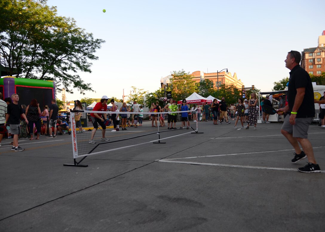 A team of Airmen from the 28th Civil Engineer Squadron volunteered their time to help set up for Summer Nights in downtown Rapid City, S.D., July 19, 2018. The Airmen moved tables and trash cans to the downtown area, while another group completed the set up. Summer Nights is a free event which takes place every Thursday night during the summer, providing live music and entertainment.