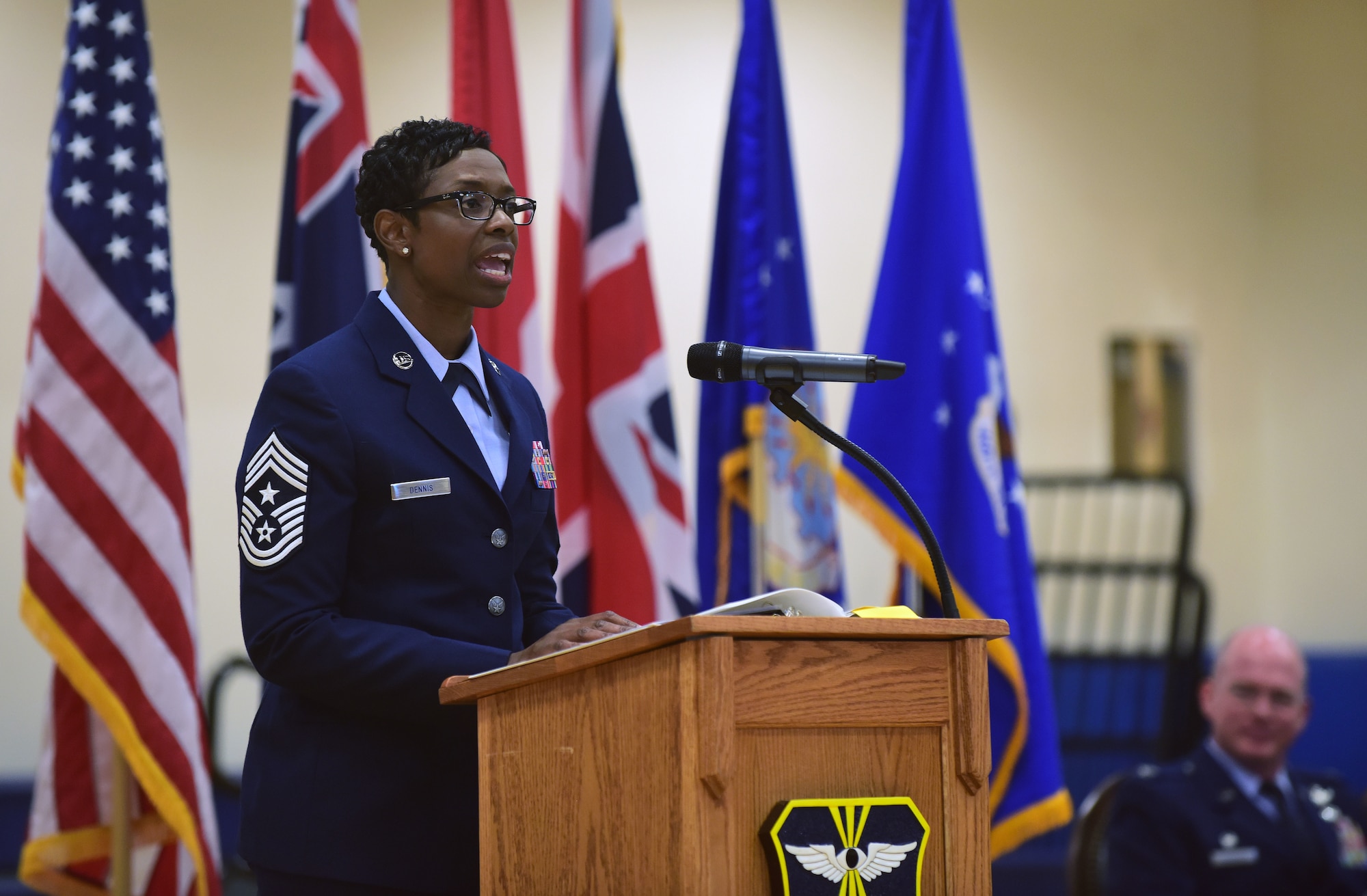 Chief Master Sgt. Tamar Dennis, 460th Space Wing command chief, addresses members of Team Buckley on the importance of striving for excellence during a change of responsibility ceremony on Buckley Air Force Base, Colorado, July 20, 2018.