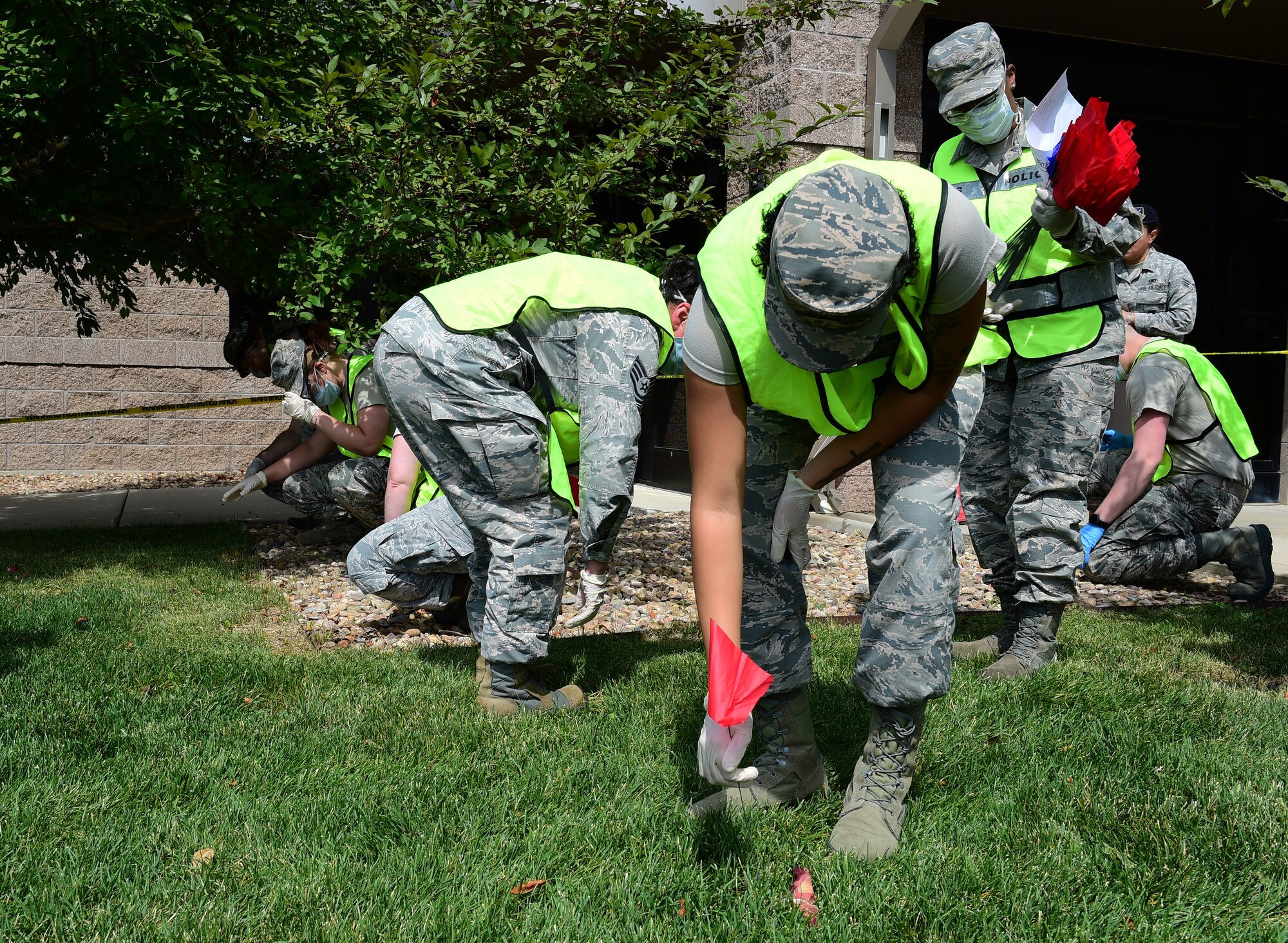 Airmen from the 460th Force Support Squadron simulate searching for human remains and personal belongings as part of search and recovery training on July 19, 2018, on Buckley Air Force Base, Colorado. To provide a realistic experience, the trainers used pieces of meat to simulate the remains. (U.S. Air Force photo by Senior Airman AJ Duprey)
