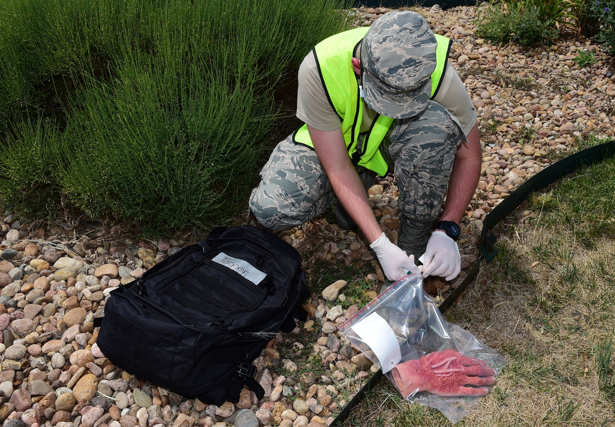 An Airman from the 460th Force Support Squadron simulates tagging a human hand as part of search and recovery training on July 19, 2018 on Buckley Air Force Base, Colorado. The training ensures Airmen are prepared for crisis response situations. (U.S. Air Force photo by Senior Airman AJ Duprey)