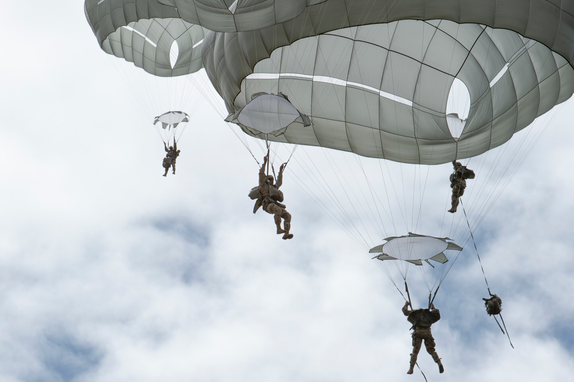 Paratroopers from U.S. Army Alaska’s 4th Infantry Brigade Combat Team (Airborne), 25th Infantry Division descend toward Malemute Drop Zone at Joint Base Elmendorf-Richardson, Alaska, July 17, 2018. More than 400 Soldiers parachuted as part of a field training exercise, executing tactical movements and setting up defensive positions while performing an airfield assault.