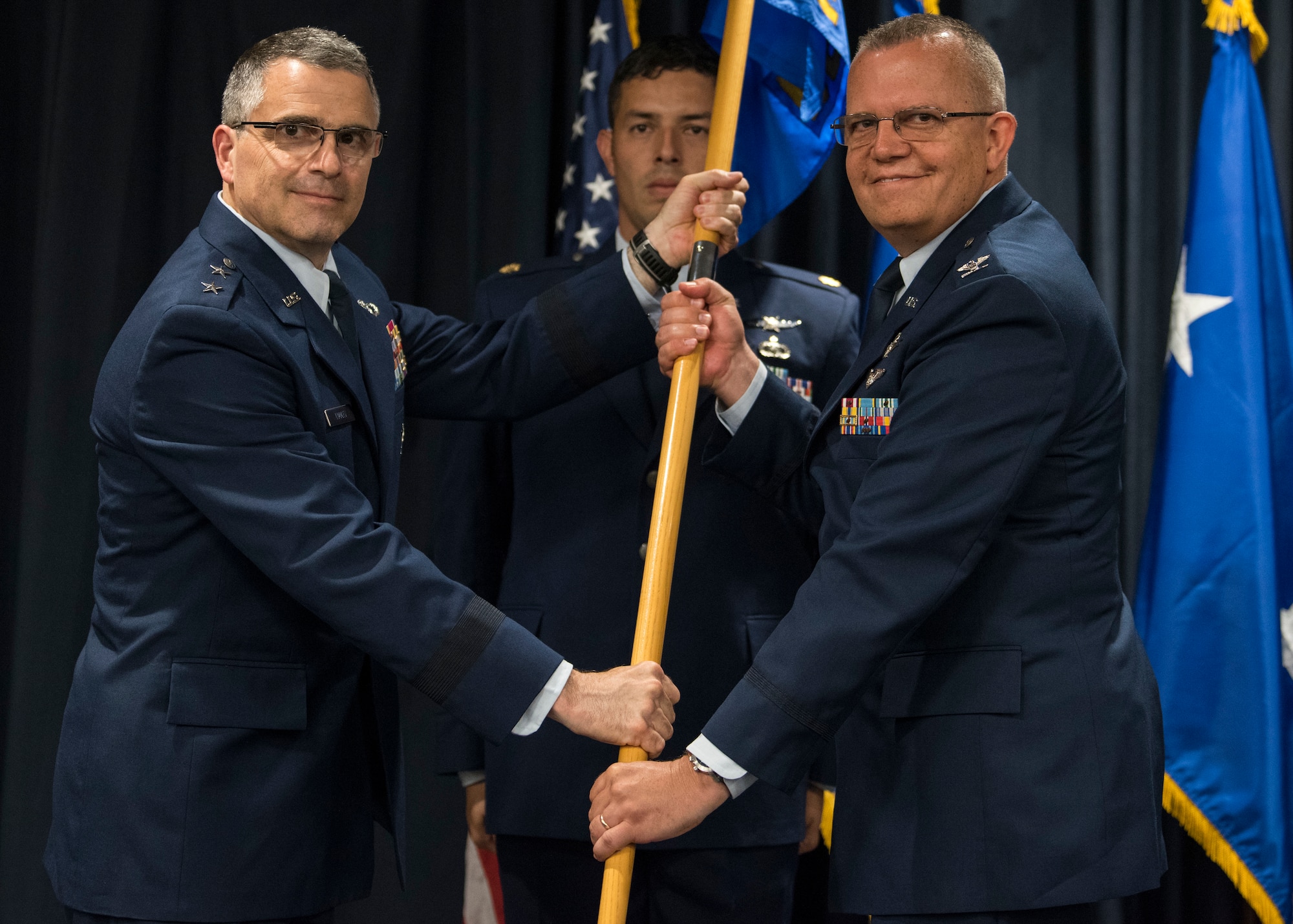 U.S. Air Force Maj. Gen. William Cooley, Air Force Research Lab commander, presents the Phillips Research Site guidon to Col. Eric Felt, Phillips Research Site commander, at Kirtland Air Force Base, N.M., July 20. Prior to commanding the Phillips Research Site, Felt served as the Director of Intelligence and Analysis, Headquarters Air Force Operational Test and Evaluation Center. (U.S. Air Force photo by Staff Sgt. J.D. Strong II)