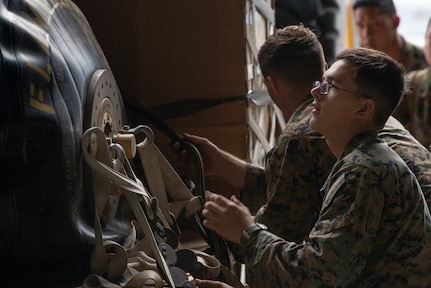 Marines of the 3d Transportation Support Battalion, VMGR-152, and Marine Wing Support Squadron 172 are participating in Exercise Kodiak Mace. During the exercise, through July 25, Marines are conducting joint precision air drop system, cargo, and personnel airdrops.