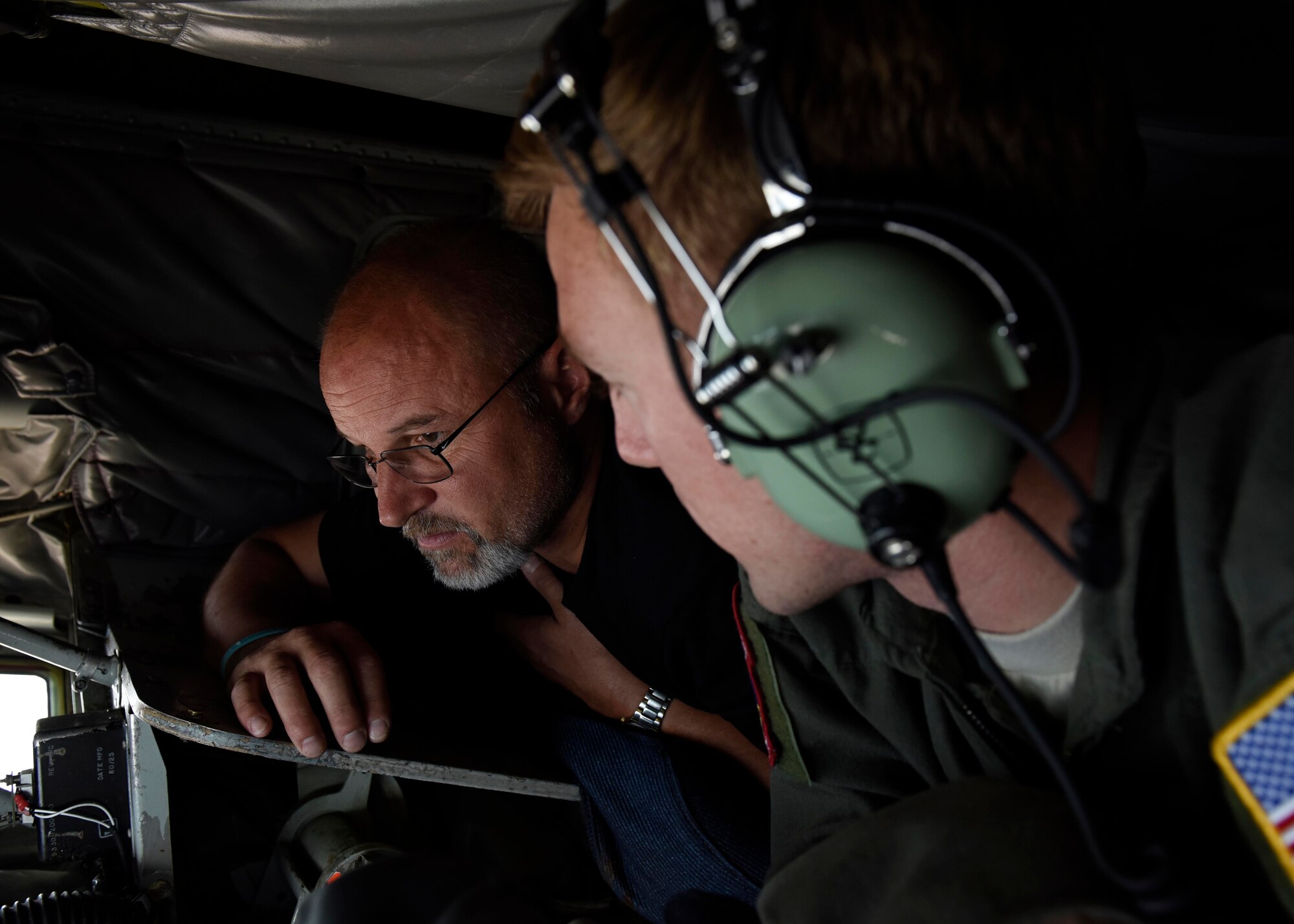 Airman 1st Class Conner O’Connell, 93rd Air Refueling Squadron boom operator, explains how a KC-135 Stratotanker boom works to Marcus Morgan, Reardon School District superintendent, during an orientation flight at Fairchild Air Force Base, Washington, July 18, 2018. This year marks the 60th year the KC-135 has been at Fairchild Air Force Base. With nearly 155 KC-135s assigned to active-duty and more than 170 assigned to the Air National Guard, Fairchild’s 44 birds make it the largest tanker fleet in the world.